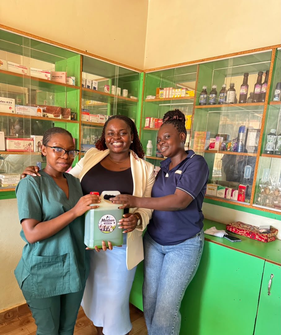 Stella Kipande at her drug shop, with her liquid soap product